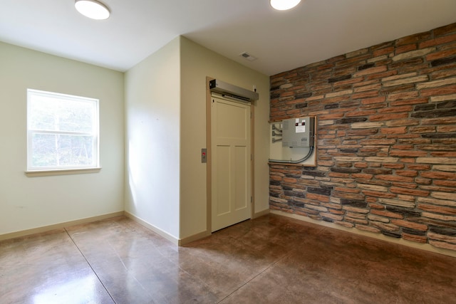 unfurnished room featuring a barn door