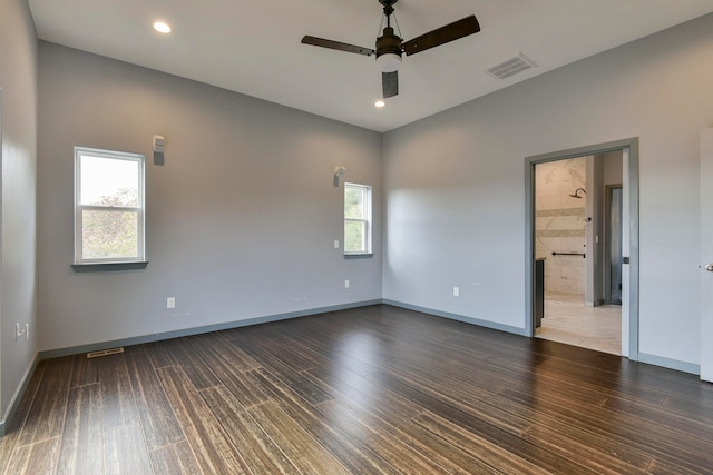 spare room featuring ceiling fan and dark hardwood / wood-style flooring