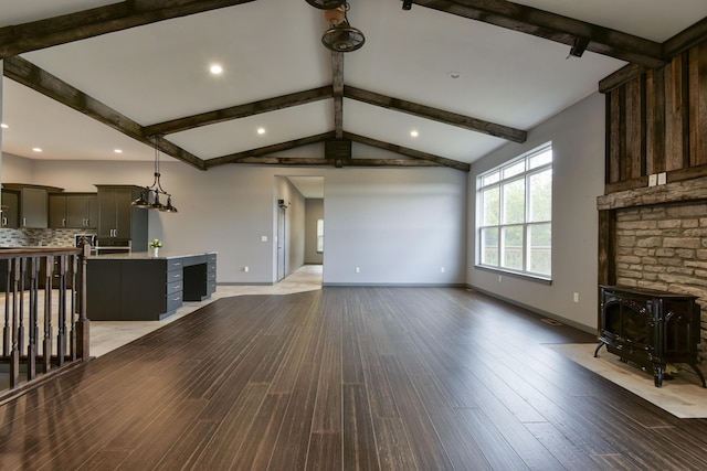 3133 Talking Rocks Rd, Reeds Spring, MO 65737 - unfurnished living room featuring baseboards, wood finished floors, a wood stove, and recessed lighting