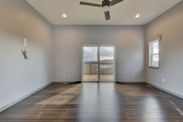 unfurnished room with ceiling fan, a healthy amount of sunlight, and dark hardwood / wood-style flooring