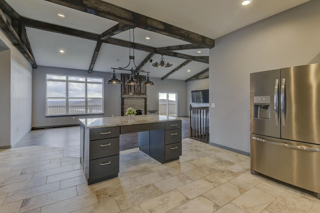 3133 Talking Rocks Rd, Reeds Spring, MO 65737 - kitchen with stainless steel fridge, a kitchen island, baseboards, recessed lighting, and light stone countertops