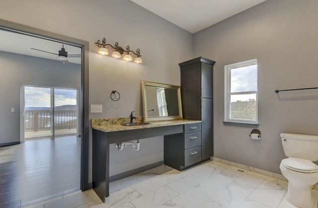 3133 Talking Rocks Rd, Reeds Spring, MO 65737 - bathroom featuring toilet, baseboards, vanity, and marble look tile flooring