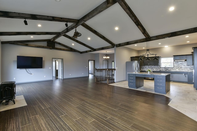 3133 Talking Rocks Rd, Reeds Spring, MO 65737 - unfurnished living room with recessed lighting, a wood stove, baseboards, wood finished floors, and a chandelier