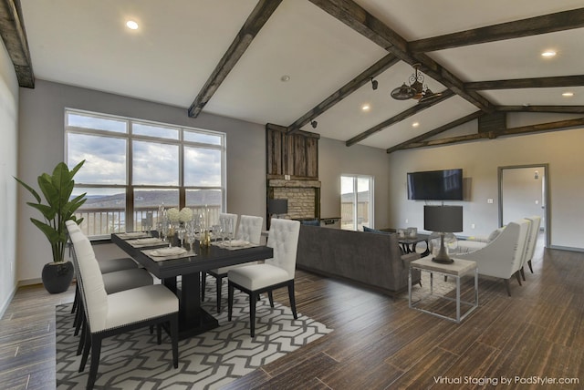 dining room featuring dark wood-type flooring, a wealth of natural light, and vaulted ceiling with beams