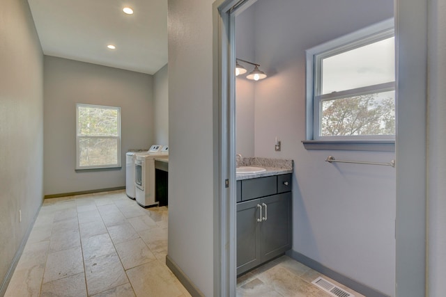 bathroom with vanity and washing machine and dryer