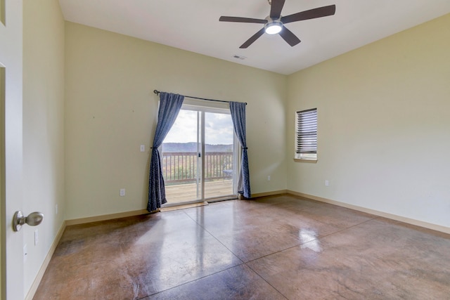 unfurnished room featuring ceiling fan and concrete flooring