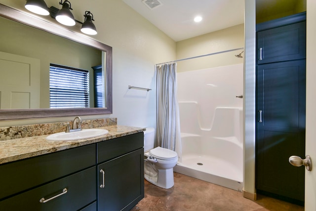 bathroom with toilet, walk in shower, and vanity