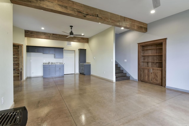 3133 Talking Rocks Rd, Reeds Spring, MO 65737 - unfurnished living room featuring ceiling fan, concrete flooring, stairs, baseboards, and beamed ceiling