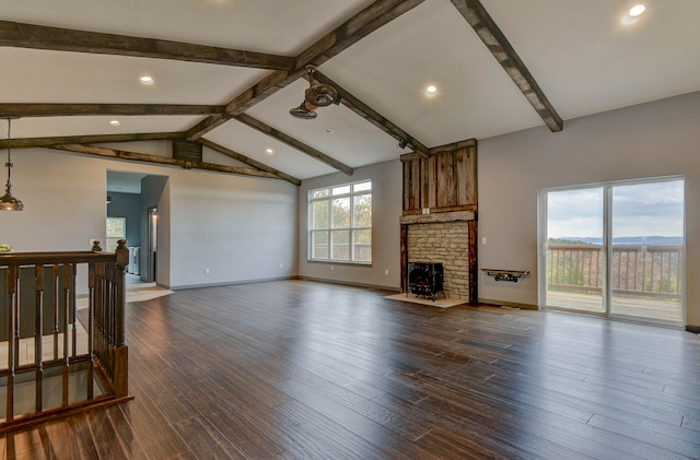 living room with dark hardwood / wood-style floors, lofted ceiling with beams, and a fireplace