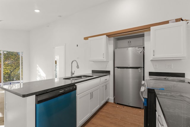 kitchen with sink, appliances with stainless steel finishes, white cabinets, and light wood-type flooring