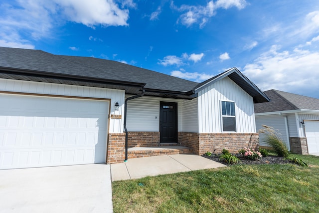 view of front of property featuring a garage and a front lawn