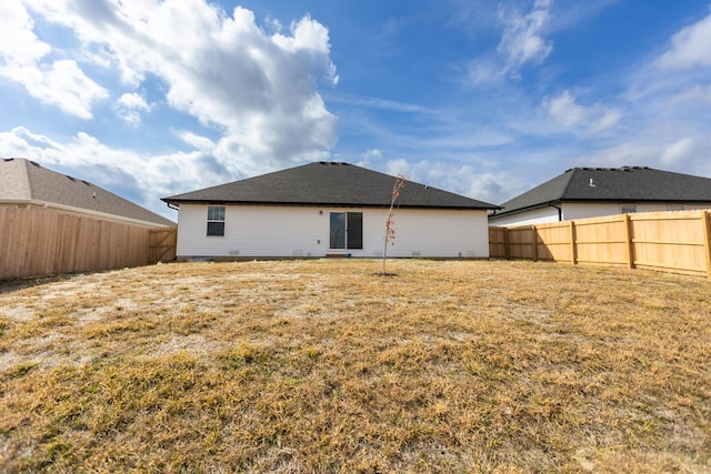 rear view of property with a yard