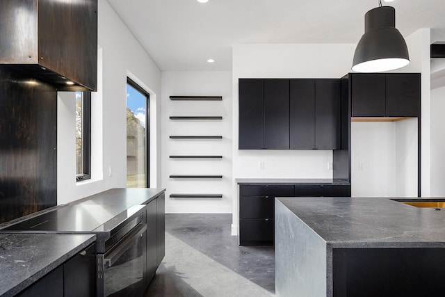 kitchen featuring hanging light fixtures and stainless steel stove