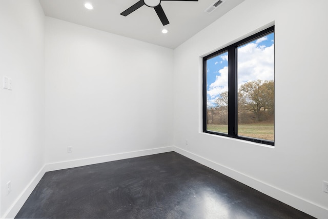 empty room with a wealth of natural light and ceiling fan