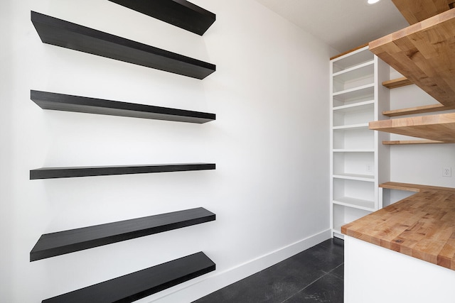 spacious closet with dark tile patterned flooring