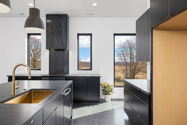 kitchen featuring stainless steel dishwasher, sink, and decorative light fixtures