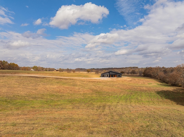 view of yard featuring a rural view and an outdoor structure