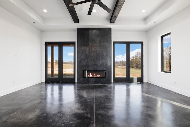 unfurnished living room featuring ceiling fan, french doors, a healthy amount of sunlight, and beam ceiling