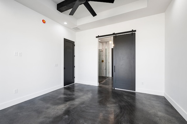 empty room featuring beamed ceiling, a barn door, and ceiling fan