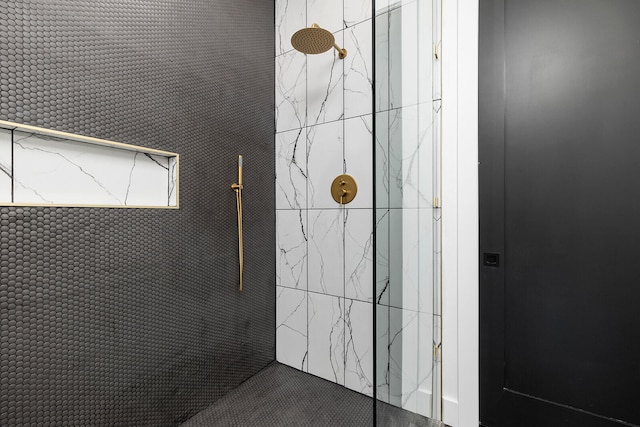 bathroom with tiled shower