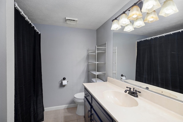 bathroom with a textured ceiling, toilet, vanity, a notable chandelier, and tile patterned flooring