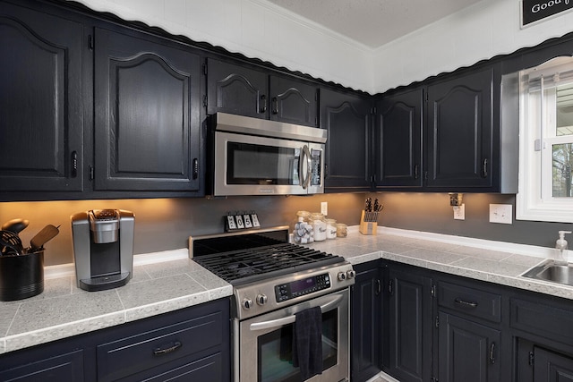 kitchen featuring ornamental molding, sink, and appliances with stainless steel finishes