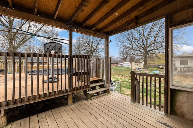 wooden terrace with a lawn