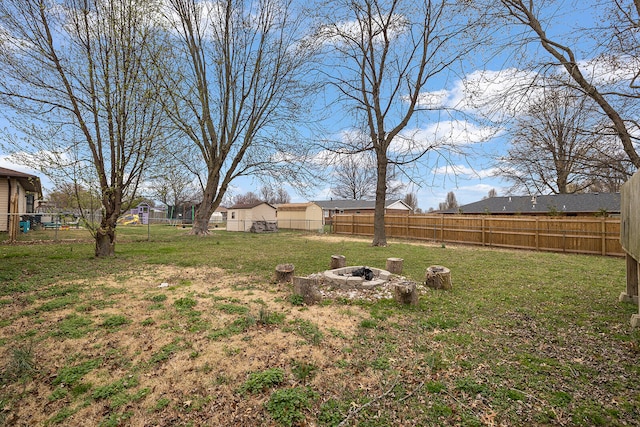 view of yard with an outdoor fire pit