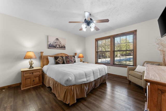 bedroom with a textured ceiling, dark hardwood / wood-style floors, and ceiling fan