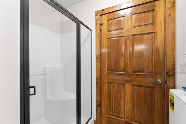 bathroom with toilet and an enclosed shower