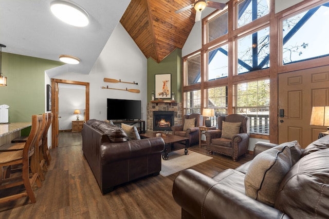 living room with dark hardwood / wood-style floors, high vaulted ceiling, and a fireplace