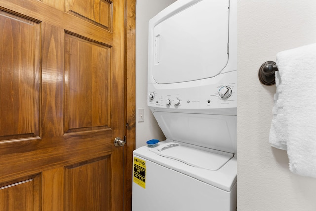 laundry room with stacked washer / dryer