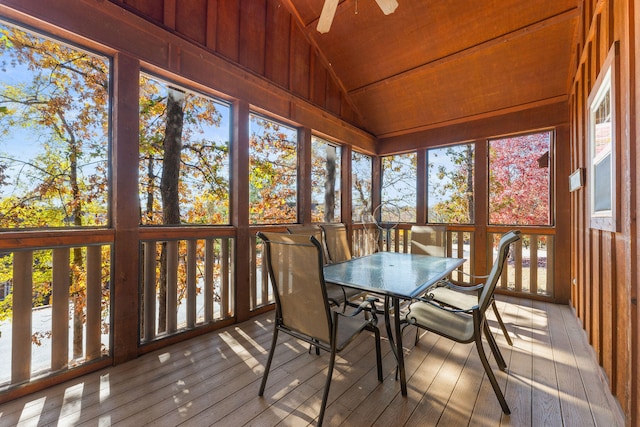 unfurnished sunroom featuring ceiling fan, a healthy amount of sunlight, vaulted ceiling, and wood ceiling