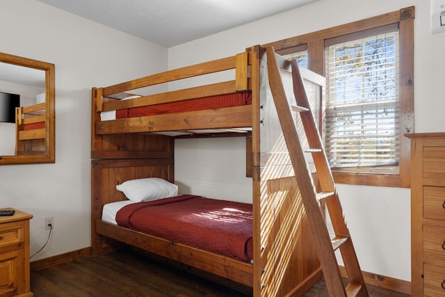 bedroom featuring dark wood-type flooring and multiple windows