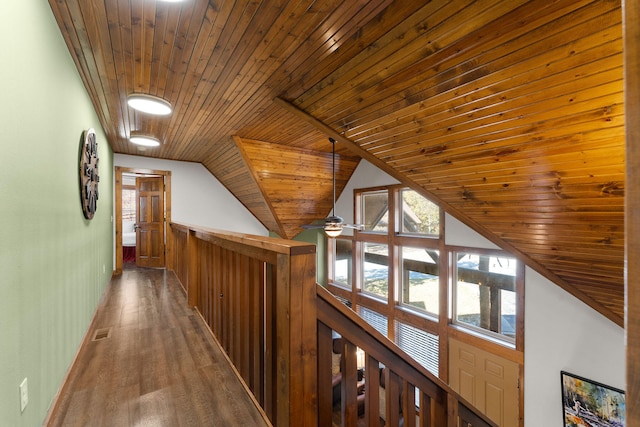 corridor with vaulted ceiling, wood-type flooring, and wooden ceiling