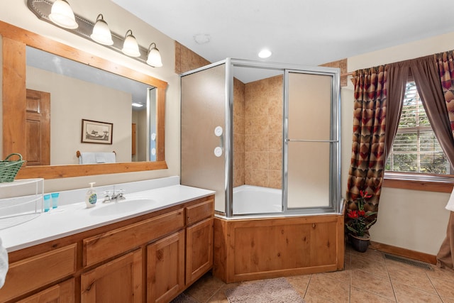 bathroom with vanity, tile patterned flooring, and bath / shower combo with glass door