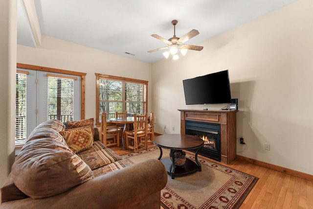24 Baldknobber Dr Unit 18, Branson West, MO 65737 - living room with light wood finished floors, ceiling fan, and a glass covered fireplace
