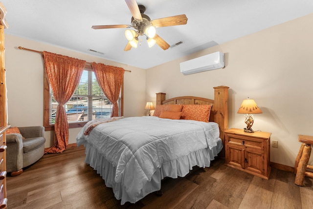 bedroom featuring an AC wall unit, dark hardwood / wood-style flooring, and ceiling fan