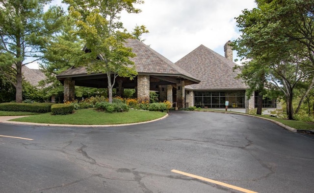 24 Baldknobber Dr Unit 18, Branson West, MO 65737 - view of front of house with stone siding, asphalt driveway, and a chimney
