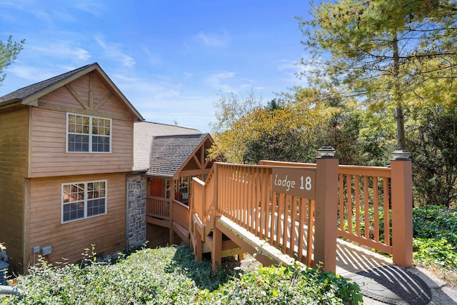 back of property featuring a wooden deck