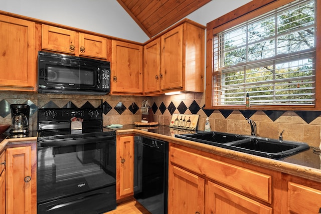 kitchen with backsplash, sink, black appliances, vaulted ceiling, and light hardwood / wood-style floors