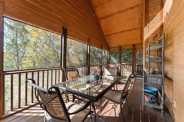 unfurnished sunroom featuring lofted ceiling and plenty of natural light