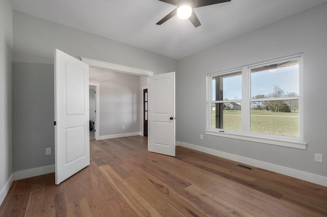 unfurnished bedroom with light hardwood / wood-style flooring and ceiling fan