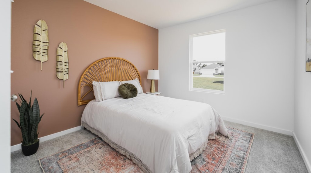 bedroom with light colored carpet