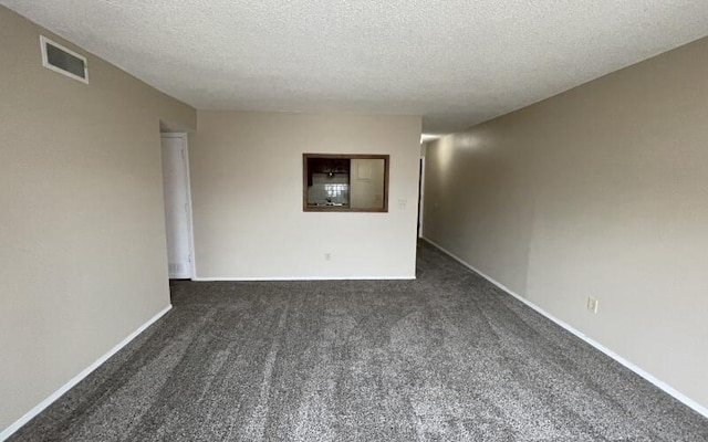 933 S Wildan Ave, Springfield, MO 65802 - empty room with dark colored carpet, a textured ceiling, and baseboards