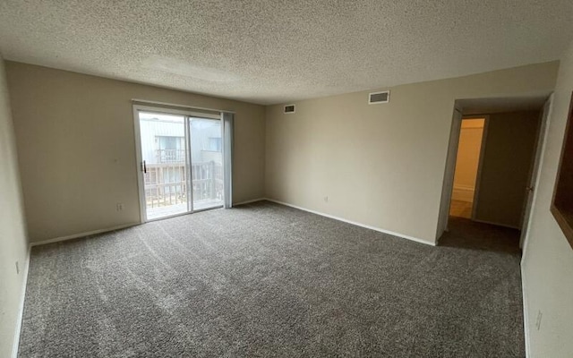 unfurnished room with dark colored carpet and a textured ceiling