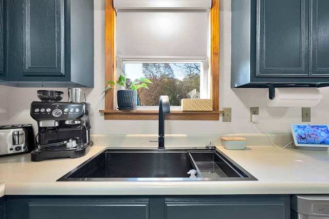 kitchen featuring blue cabinets and sink