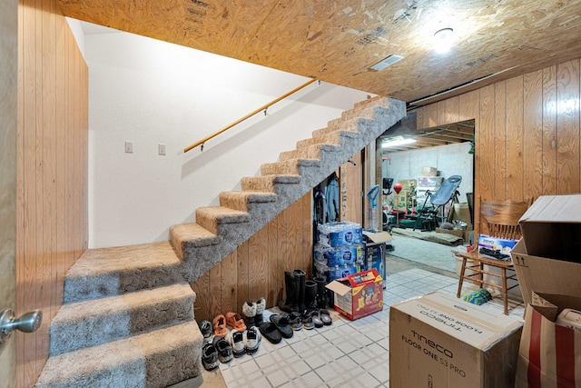 staircase with wood walls