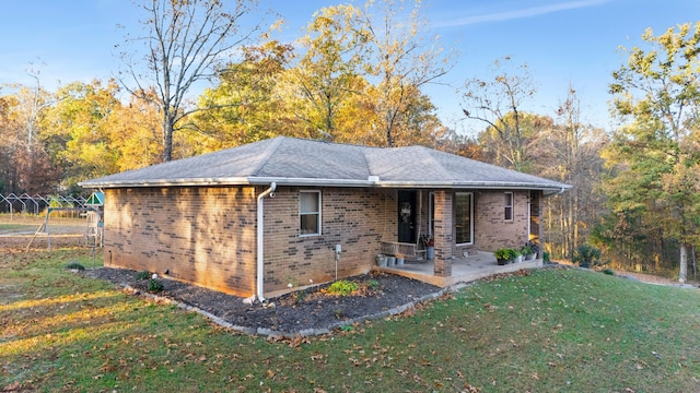 exterior space with a front yard and a patio