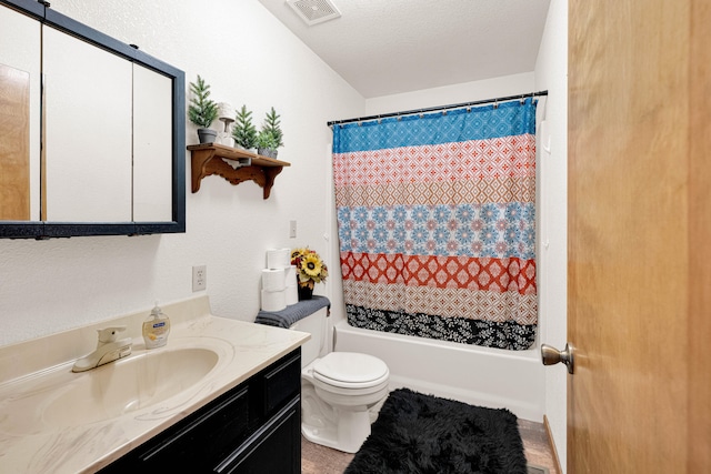 full bathroom with vanity, shower / tub combo, a textured ceiling, and toilet